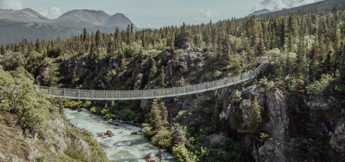 suspension bridge river crossing camping hiking canyon trail